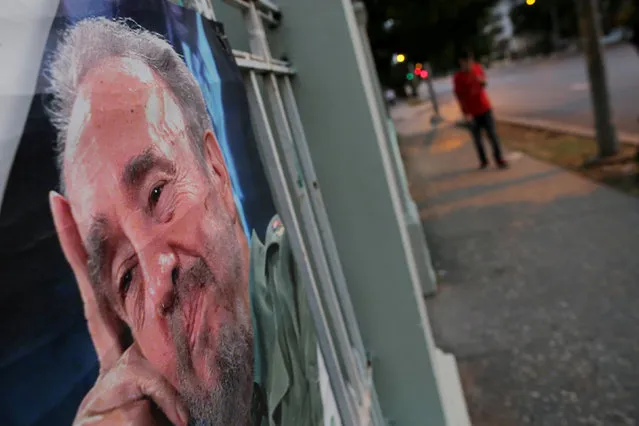 A picture of Fidel Castro as a local is seen on a wall as a resident walks along an empty street, following the announcement of the death of Cuban revolutionary leader, in Havana, Cuba November 27, 2016. (Photo by Carlos Barria/Reuters)