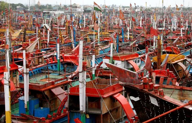 Fishing boats are docked ahead of Cyclone Tauktae at a harbour in Veraval in the western state of Gujarat, India, May 17, 2021. (Photo by Amit Dave/Reuters)