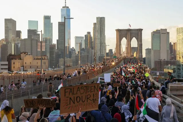 People march over the Brooklyn Bridge as Pro-Palestinian protesters attend “Flood Brooklyn for Gaza” demonstration, as the conflict between Israel and the Palestinian Islamist group Hamas continues, in New York, U.S., October 28, 2023. (Photo by Caitlin Ochs/Reuters)