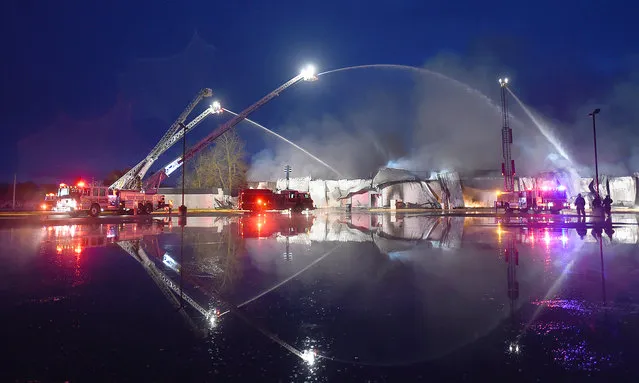 Ladder trucks from Lebanon, Ore., Corvallis, Ore., and Albany, Ore., battle a 4-alarm fire that destroyed the cafeteria of South Albany High School, early Wednesday, April 1, 2015. There was no immediate report of injuries or what caused the fire. (Photo by Mark Ylen/AP Photo/Albany Democrat-Herald)