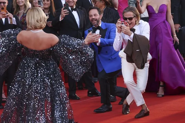 Chris Pine, right, and Nick Kroll, center, take pictures of Florence Pugh upon arrival at the premiere of the film “Don't Worry Darling” during the 79th edition of the Venice Film Festival in Venice, Italy, Monday, September 5, 2022. (Photo by Joel C. Ryan/Invision/AP Photo)