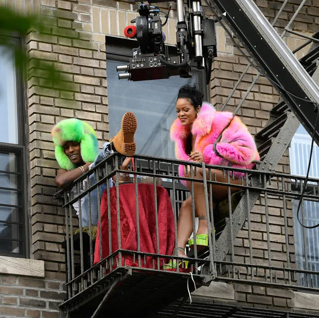 Rihanna and American rapper A$AP Rocky film scenes on a balcony in The Bronx in New York City on July 11, 2021. Rihanna wore a pink fur coat, jean shorts, and neon green platform heels before changing into a red silk dress. A$AP cooled off by treating some neighborhood residents to shave ice and then dancing in the street under the spray of water from a fire hydrant. (Photo by The Image Direct)
