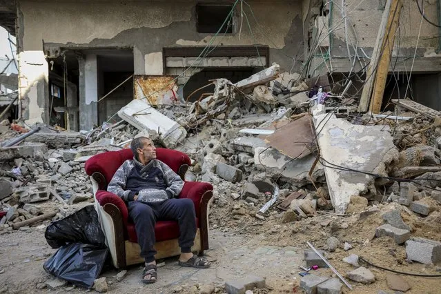 A Palestinian man sits in an armchair outside a destroyed building in Gaza City on Wednesday, November 29, 2023, the sixth day of the temporary cease-fire between Hamas and Israel. International mediators on Wednesday worked to extend the truce in Gaza, encouraging Hamas militants to keep freeing hostages in exchange for the release of Palestinian prisoners and further relief from Israel's air and ground offensive. (Photo by Mohammed Hajjar/AP Photo)