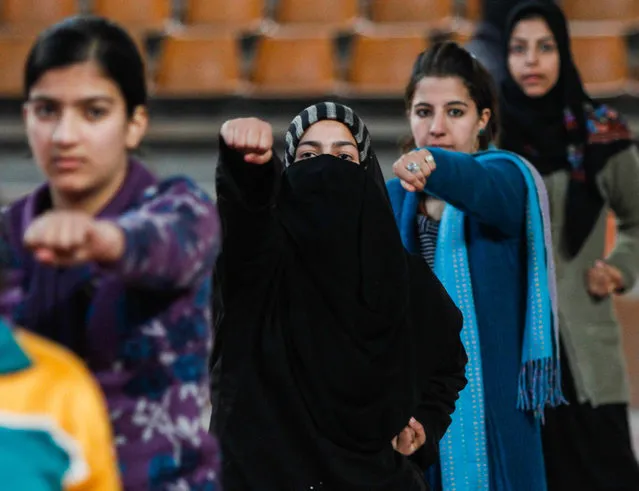 Kashmiri Muslim girls learn martial arts inside indoor stadium on December 16, 2013 in Srinagar, the summer capital of Indian administered Kashmir, India. As the number of crimes against women has risen in the region, girls from different age groups and backgrounds have taken up martial arts and other self defence courses to thwart attackers. (Photo by Yawar Nazir/Getty Images)