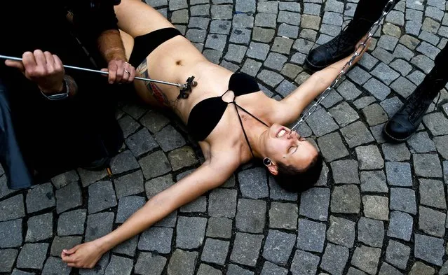 An animal rights activist is branded with number 269 in Prague, Czech Republic, on June 26, 2013. Activists from 269 Life movement have adopted the act of human branding to raise awareness about animal rights. (Photo by Petr David Josek/Associated Press)