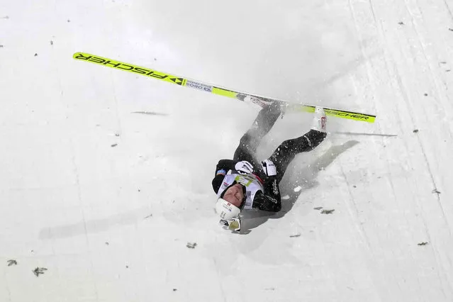 Jens Luraas Oftebro of Norway crashes the landing at the men's Individual Mass Start HS98 competition at the Nordic Combined World Cup in Ramsau, Austria, Friday, December  15, 2023. (Photo by Matthias Schrader/AP Photo)