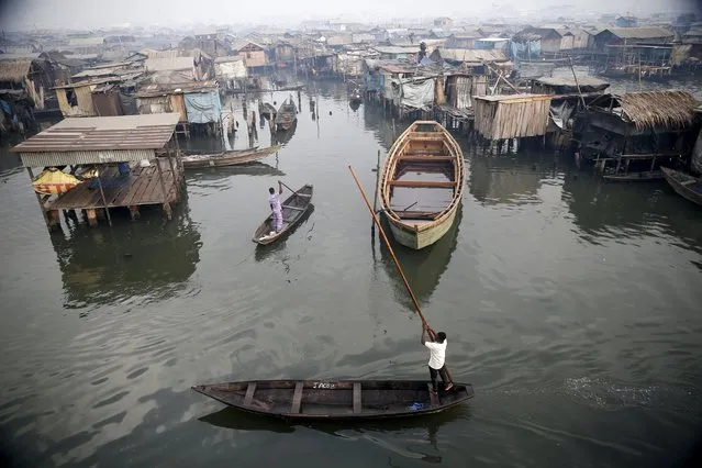 A view of the Makoko fishing community is seen from top of a floating school on the Lagos Lagoon, Nigeria February 29, 2016. In Makoko, a sprawling slum of Nigeria's megacity Lagos, a floating school capable of holding up to a hundred pupils has since November brought free education to the waterways known as the Venice of Lagos. It offers the chance of social mobility for youngsters who, like most of the city's 21 million inhabitants, lack a reliable electricity and water supply and whose water-based way of life is threatened by climate change as well as rapid urbanisation. (Photo by Akintunde Akinleye/Reuters)