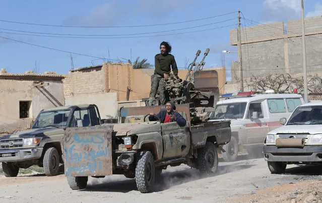 Members of East Libyan forces ride a vehicle after taking control of Ganfouda district in Benghazi, Libya January 26, 2017. (Photo by Esam Omran Al-Fetori/Reuters)