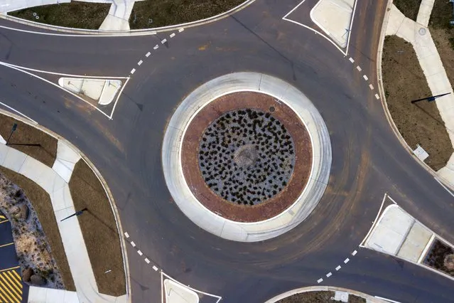 A drone image shows a suburban roundabout during lockdown in Canberra, 19 August 2021. Sydney's dire coronavirus case numbers could affect Canberra's restrictions as the nation's capital remains vulnerable to leakage from New South Wales (NSW). (Photo by Lukas Coch/EPA/EFE)