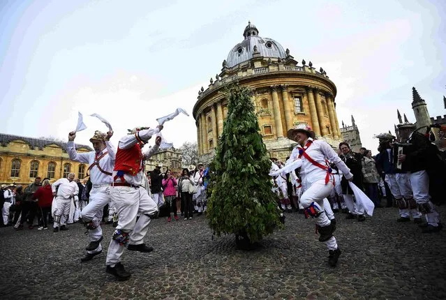 Morris Dancers celebrate beside the Radcliffe Camera in the early hours during traditional May Day celebrations in Oxford, Britain, May 1, 2015. (Photo by Dylan Martinez/Reuters)