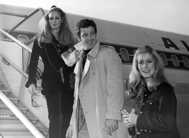 In this November 29, 1968 file photo, actress Ursula Andress, left, joins Jean-Paul Belmondo, center, and Catherine Deneuve, right, on the gangway of the plane in Orly airport, France. French New Wave actor Jean-Paul Belmondo has died, according to his lawyer’s office on Monday Sept. 6, 2021. (Photo by AP Photo/File)