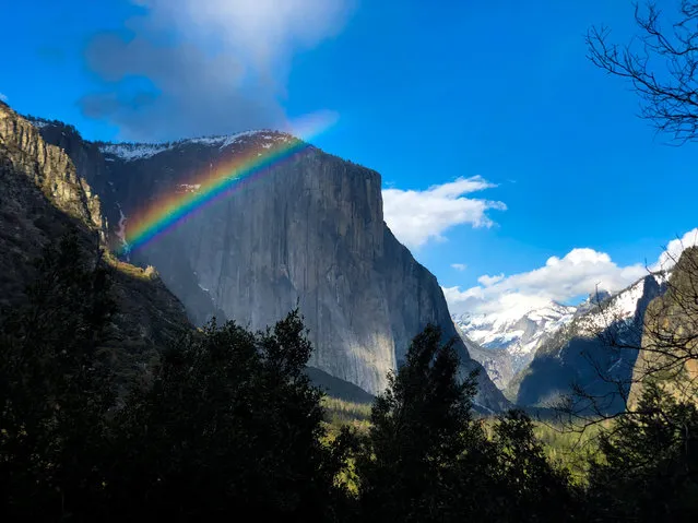 A rainbow is seen across the Yosemite Valley in front of El Capitan granite rock formation in Yosemite National Park, California, U.S., March 29, 2019. National Park Week begins April 20, 2019. (Photo by Lucy Nicholson/Reuters)
