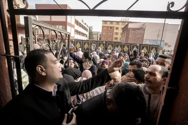 Egyptian voters crowd to cast their votes for the presidential elections at a polling station, in Cairo, Egypt, Sunday, December 10, 2023. Egyptians began voting Sunday in a presidential election in which President Abdel Fattah el-Sissi, who faces no serious challenger, is certain to win another term, keeping him in power until 2030. (Photo by Amr Nabil/AP Photo)