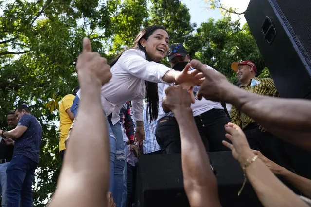 Aurora Silva greets supporters after she was named the new Democratic Unity Roundtable gubernatorial candidate for Barinas State, during a demonstration in support of her husband, opposition leader Freddy Superlano, in Barinas, Venezuela, Saturday, December 4, 2021. Superlano, who was leading the race for governor in Barinas State in the recent Nov. 21 regional elections, called for a protest this Saturday after a court ruling ordered new elections in the state and disqualified him from running. (Photo by Ariana Cubillos/AP Photo)