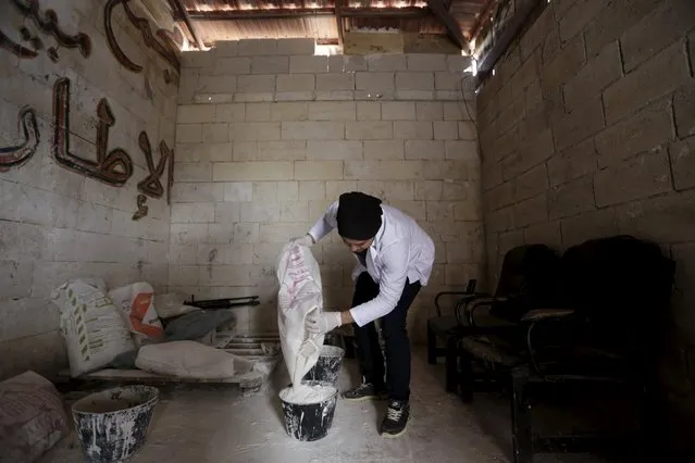 Khamis, 24, pours gypsum in a bucket to make a mould for an artificial limb inside a workshop in the rebel-controlled area of Maaret al-Numan town in Idlib province, Syria March 20, 2016. (Photo by Khalil Ashawi/Reuters)