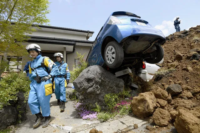 Police officers conduct a search operation at the site of a landslide caused by an earthquake in Minamiaso, Kumamoto prefecture, Japan, Sunday, April 17, 2016. Two nights of increasingly terrifying earthquakes flattened houses and triggered major landslides in southern Japan. (Photo by Yohei Fukai/Kyodo News via AP Photo)