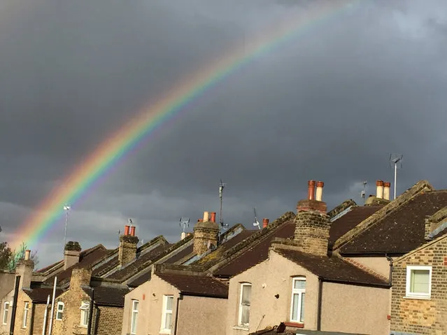 A rainbow forms over terraced housing during a rain storm in south London April 9, 2016. (Photo by Russell Boyce/Reuters)