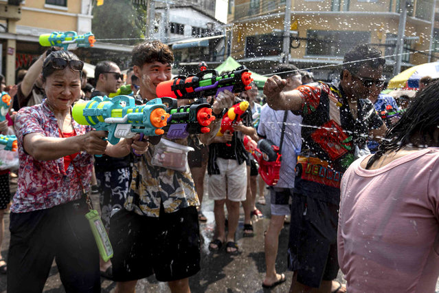 Thai locals and tourists play with water guns during the Songkran water festival to celebrate the Thai New Year in Bangkok, Thailand, Saturday April 13, 2024. (Photo by Tananchai Keawsowattana/AP Photo)