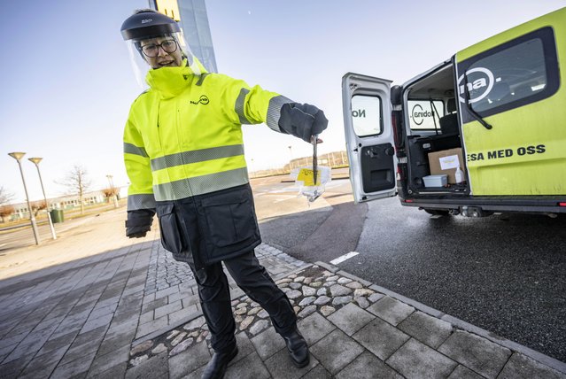A member of staff collects the last COVID-19 PCR tests, at the Covid testing site of Svagertorp, Malmoe, Sweden, Tuesday, February 8, 2022. Starting Wednesday, Sweden ends the wide-scale testing for COVID-19 even among people showing symptoms of coronavirus infection, a move that puts the Scandinavian nation at odds with most of Europe but could become the norm as the costs of testing yields fewer benefits as the omicron variant proves milder and governments begin to consider treating covid-19 as other endemic illnesses. (Photo by Johan Nilsson/TT News Agency via AP Photo)