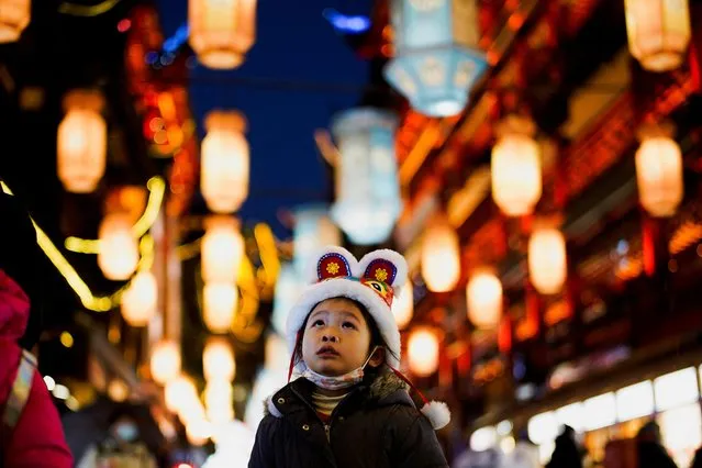 A girl visits by an area decorated with lanterns ahead of the Chinese Lunar New Year festivity at Yu Garden, following the new coronavirus disease (COVID-19) cases in Shanghai, China, January 28, 2022. (Photo by Aly Song/Reuters)