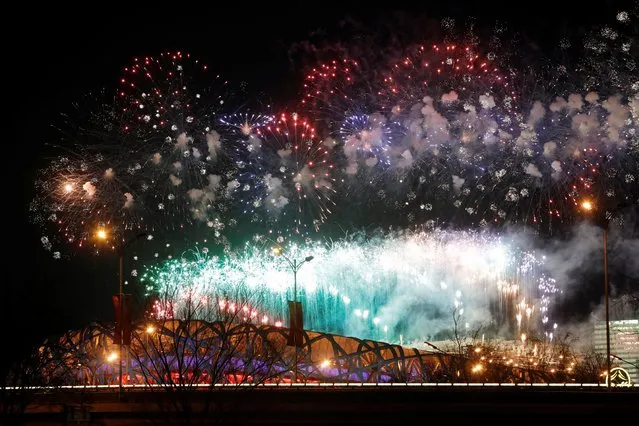 A general view of fireworks light up the sky above the National Stadium, known as the Bird's Nest, during the closing ceremony of the Beijing 2022 Winter Olympic Games in Beijing, on February 20, 2022. (Photo by Carlos Garcia Rawlins/Reuters)