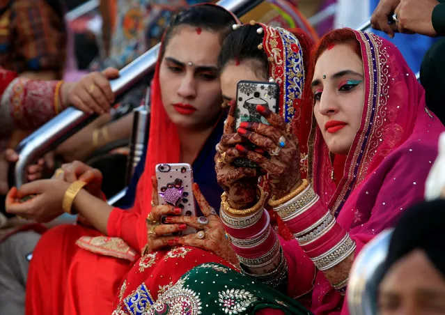 Sikh devotees use their mobile phones to take a selfie during the Baisakhi festival at the holy temple of Panja Sahib in Hassan Abdal, Pakistan April 14, 2017. (Photo by Faisal Mahmood/Reuters)