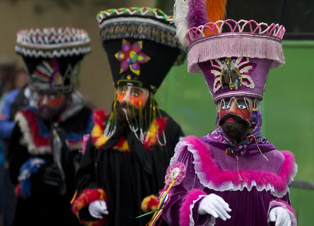 Costumed performers dance during a festival celebrating a 400-year-old representation of the Baby Jesus, in Xochimilco, on the southern edge of Mexico City, Wednesday, May 7, 2014. In Xochimilco, busy markets stand side by side with colonial churches, and children ride to school in boats pushed by poles, along a network of canals and floating gardens that date to pre-hispanic times. The popular tourist destination was declared a UNESCO world heritage site in 1987. (Photo by Rebecca Blackwell/AP Photo)