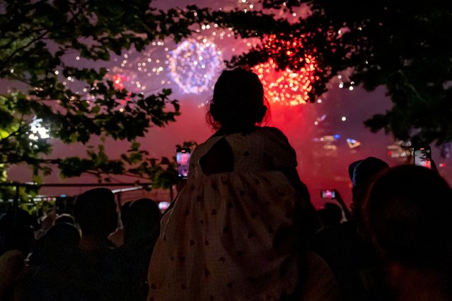 A girl watches Macy's Fourth of July fireworks over New York, Thursday, July 4, 2024, in Hoboken, N.J. (Photo by Julia Nikhinson/AP Photo)