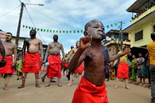 A child of the “Blessoue Djehou generation” in initiation dances on August 22, 2019 in a street of Adjame village in Abidjan during the “Fatchue” ceremony. The “Fatchue” ceremony mark the passage of individuals from one generation to the next with dances and rituals. The “Blessoue Djehou” generation is mature in age and is the next generation to participate in the management of village affairs. (Photo by Sia Kambou/AFP Photo)