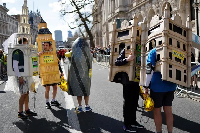 Runners dressed-up as famous London's building speak together after competing in the 2022 London Landmarks Half Marathon, in London, on April 3, 2022. (Photo by Tolga Akmen/AFP Photo)
