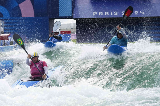 Pedro Goncalves of Brazil competes in the men's kayak cross against Quan Xin of China and Amir Rezanejad of the Refugee Olympic Team at the 2024 Summer Olympics, Saturday, August 3, 2024, in Vaires-sur-Marne, France. (Photo by Lindsey Wasson/AP Photo)