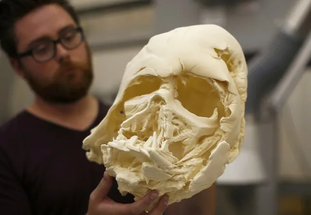 A technician holds a recently 3D printed replica of Darth Vader's melted helmet from “Star Wars: The Force Awakens”, in the Propshop headquarters at Pinewood Studios near London, Britain May 25, 2016. (Photo by Peter Nicholls/Reuters)