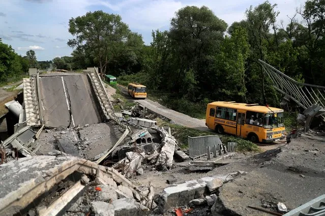 An evacuation convoy travels from Russian troop-occupied Kupiansk town, along a damaged road, amid Russia's attack on Ukraine, on the outskirts of Kharkiv, Ukraine on May 30, 2022. (Photo by Ivan Alvarado/Reuters)