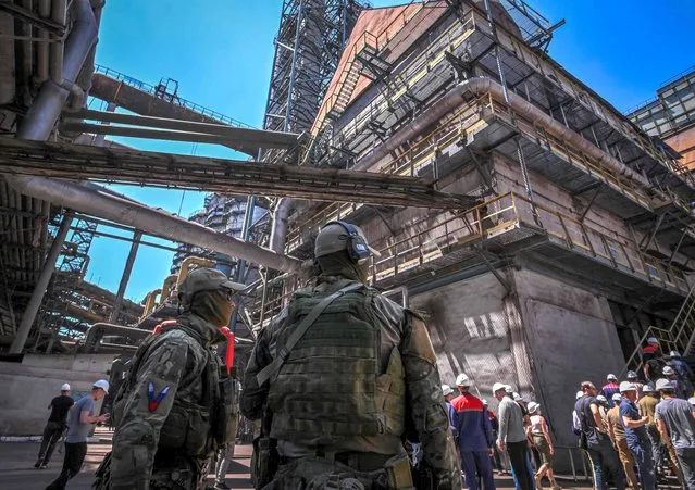 Russian servicemen patrol Alchevsk Iron and Steel Works in Alchevs'k on June 11, 2022, amid the ongoing Russian military action in Ukraine. (Photo by Yuri Kadobnov/AFP Photo)