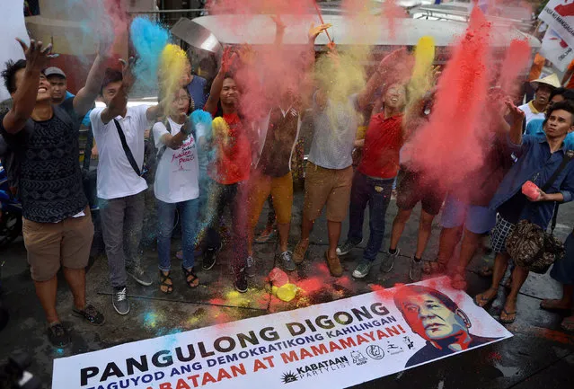 Activists throw colored powder as they welcome newly elected Philippine President Rodrigo Duterte during a rally outside the presidential palace in metro Manila, Philippines June 30, 2016. (Photo by Ezra Acayan/Reuters)