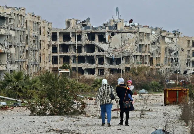 Residents of a suburban neighbourhood on the edge of the northern Syrian city of Aleppo, facing Kafr Hamra, return to their homes to check the damage caused by fighting between regime forces and rebel fighters, on February 18, 2020. Syrian troops pressed an offensive today on the country's last major rebel enclave where the mass displacement of civilians is sparking fears of a humanitarian catastrophe. Around 900,000 people have been forced from their homes and shelters in less than three months, leaving huge numbers to sleep rough in the thick of winter. (Photo by AFP Photo/Stringer)