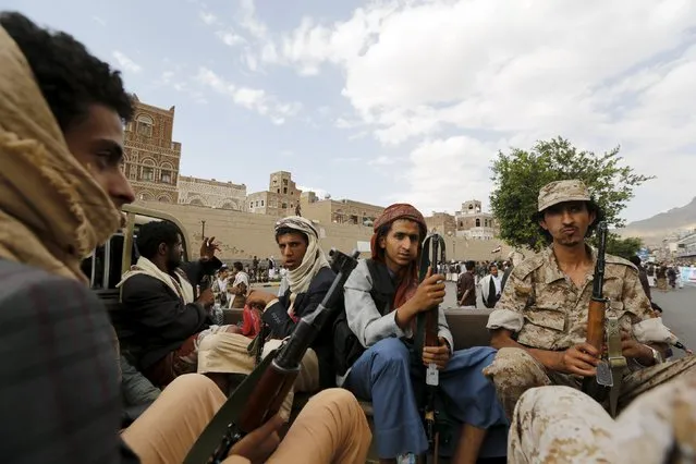 Houthi militants sit on the back of a patrol vehicle as they secure an area where fellow Houthis demonstrated against the Saudi-led air strikes in Yemen's capital Sanaa August 24, 2015. (Photo by Khaled Abdullah/Reuters)