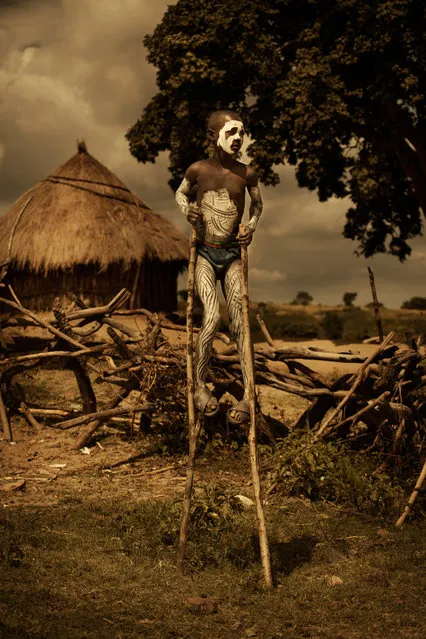 Many Mursi boys perform acrobatics on stilts when tourists come by, as a means of making extra money. (Photo by Diego Arroyo)