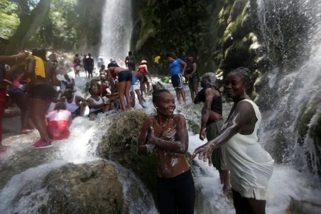Pilgrims take a bath during the celebration of the annual pilgrimage to the waterfall in Saut D'Eau, Haiti, July 16, 2016. (Photo by Andres Martinez Casares/Reuters)