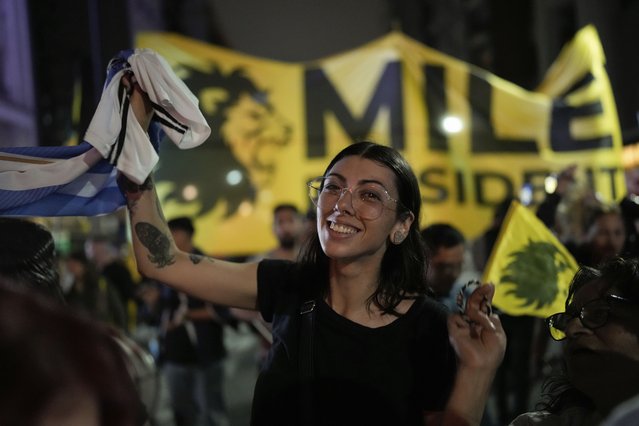 Supporters of Javier Milei, presidential candidate of the Liberty Advances coalition, gather outside his campaign headquarters after polls closed for general elections in Buenos Aires, Argentina, Sunday, October 22, 2023. (Photo by Rodrigo Abd/AP Photo)