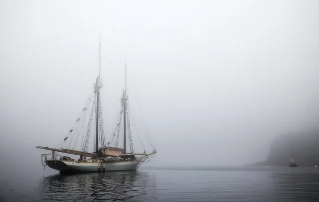 In this photo made Friday, August 3, 2012, the schooner Mary Day sits at anchor in the morning fog off South Brooksville, Maine. (Photo by Robert F. Bukaty/AP Photo)