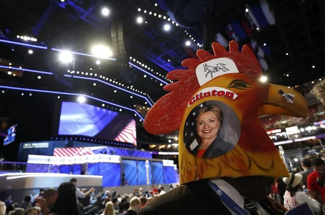 A delegate wearing rooster headgear with a picture of Democratic U.S. presidential candidate Hillary Clinton on the side walks across the floor of the convention during the second night at the Democratic National Convention in Philadelphia, Pennsylvania, U.S., July 26, 2016. (Photo by Jim Young/Reuters)