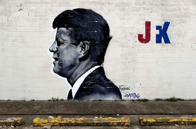 A mural of President John F. Kennedy is seen on the wall of a business, Saturday, July 9, 2016, in Dallas. After five police officers were killed in a shooting Thursday, a city forever haunted by the assassination of John F. Kennedy is trying to not let the worst America attack on police since Sept. 11 define it again. (Photo by Eric Gay/AP Photo)