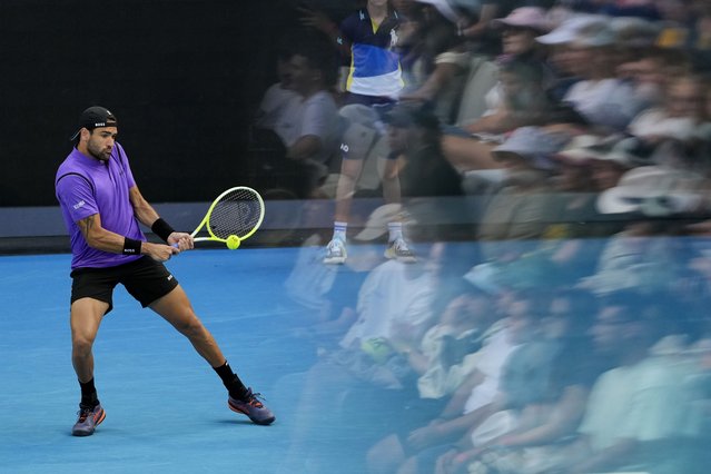 Matteo Berrettini of Italy plays a backhand return to Holger Rune of Denmark during their second round match at the Australian Open tennis championship in Melbourne, Australia, Thursday, January 16, 2025. (Photo by Vincent Thian/AP Photo)