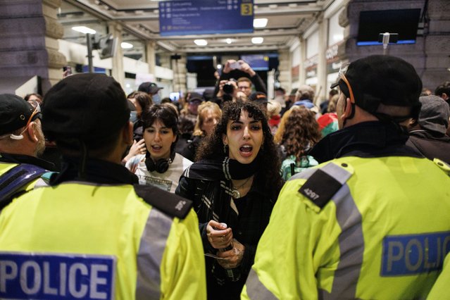 Pro-Palestinian protesters are pushed out of the station by police officers following sit-in protest at Waterloo Station to call for a ceasefire in the Israel-Hamas conflict, in London, Britain, 18 November 2023. Thousands of Israelis and Palestinians have died since the militant group Hamas launched an unprecedented attack on Israel from the Gaza Strip on 07 October, and the Israeli strikes on the Palestinian enclave which followed it. (Photo by Tolga Akmen/EPA)
