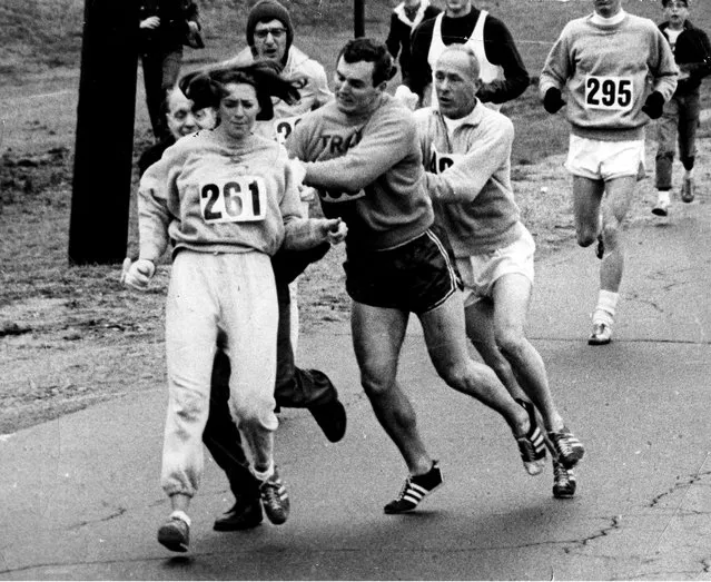 Kathy Switzer roughed up by Jock Semple during Boston Mararthon in Ashland, Ma. on April 19, 1967, a time when women were banned from participating in races. (Photo by Paul J. Connell/The Boston Globe via Getty Images)