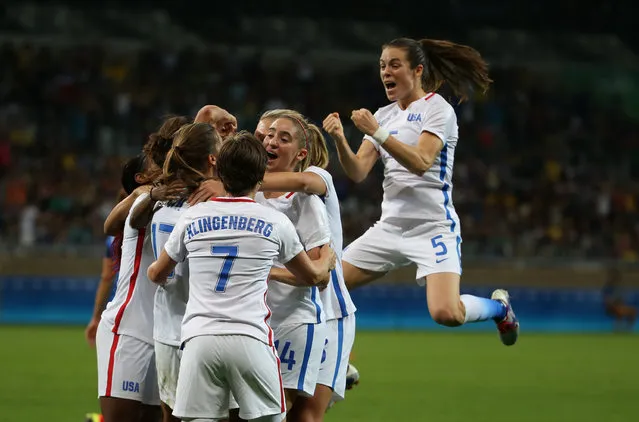 The United States Women's Olympic Football team celebrate their first goal during a group G match of the women's Olympic football tournament between United States and France at the Mineirao stadium in Belo Horizonte, Brazil, Saturday, August 6, 2016. (Photo by Eugenio Savio/AP Photo)
