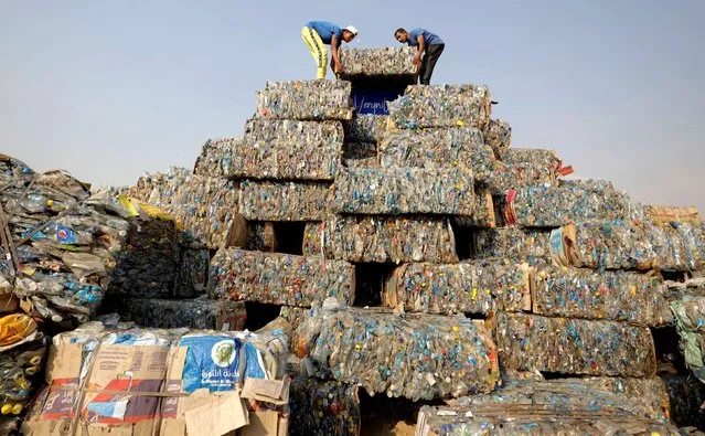 Egyptian volunteers arrange sacks with plastic wastes to build a Plastic Pyramid for The VeryNile NGO as part of a project to erect the largest plastic pyramid in the world, weighing 7,500 kg and made of plastic bottles collected by fishermen and volunteers from the Nile River, in Giza, Egypt on September 17, 2022. (Photo by Mohamed Abd El Ghany/Reuters)