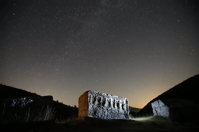 Stars and meteor streaks (near the line of horizon) are seen behind a medieval tombstone, believed to be built around 12th century depicting the ancient ritual dance, on the mountain Bjelasniaca, near the village of Umoljani, 50 kilometers (31 miles) southeast of Sarajevo, Bosnia, late Friday, August 11, 2017. The annual Perseid meteor shower will reach its peak on Saturday night. (Photo by Amel Emric/AP Photo)