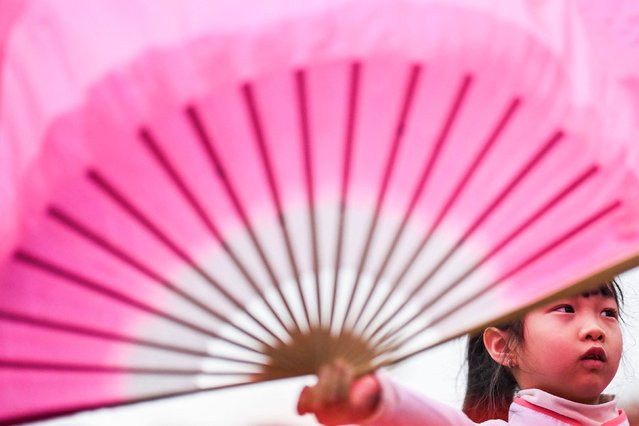 A girl holds a fan during Lunar New Year celebrations in Lisbon, Portugal, on Saturday, February 1, 2025. (Photo by Patricia de Melo Moreira/AFP Photo)